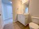 Bathroom with wood look flooring and single sink vanity at 403 Duncan Creek Rd # 131, Lillington, NC 27546