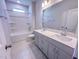 Bathroom featuring double sink vanity, tiled floors, and a shower-tub combination at 403 Duncan Creek Rd # 131, Lillington, NC 27546