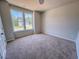 Sunny bedroom with plush carpeting and a view of the neighborhood at 403 Duncan Creek Rd # 131, Lillington, NC 27546