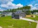 Exterior view of gray two-story house with lush yard, long driveway, and attached garage in a friendly neighborhood at 403 Duncan Creek Rd # 131, Lillington, NC 27546