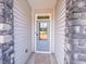 Inviting front door of the home, framed by stone accents and light-colored siding at 403 Duncan Creek Rd # 131, Lillington, NC 27546