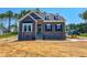 Charming two-story home with stone accents and a welcoming entrance and beautiful trees in the background at 403 Duncan Creek Rd # 131, Lillington, NC 27546