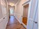 Hallway with wood-look floors and wainscoting, showcasing access to various rooms at 403 Duncan Creek Rd # 131, Lillington, NC 27546