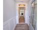 View of the hallway with wooden floors, white walls, and a clear view through to the living room at 403 Duncan Creek Rd # 131, Lillington, NC 27546