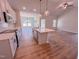 Bright kitchen features white cabinets, stainless appliances, an island, and hardwood flooring at 403 Duncan Creek Rd # 131, Lillington, NC 27546