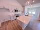 A modern kitchen boasts white cabinets, stainless appliances, and a spacious island perfect for meal preparation and entertaining at 403 Duncan Creek Rd # 131, Lillington, NC 27546