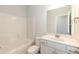 Bright bathroom featuring a white vanity, a toilet, and a bathtub with a shower at 590 Glenkirk Pl, Garner, NC 27529