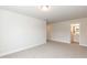 Bedroom with plush carpet and a view to the ensuite bathroom at 590 Glenkirk Pl, Garner, NC 27529