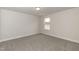 Cozy bedroom with plush carpet, window, and neutral paint at 590 Glenkirk Pl, Garner, NC 27529