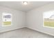 Bedroom with two windows and carpeted floor at 590 Glenkirk Pl, Garner, NC 27529
