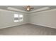 Spacious bedroom with trey ceilings, neutral walls, carpet, and a bright window at 590 Glenkirk Pl, Garner, NC 27529