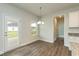 Cozy dining area with natural light, wood floors, and a view to the backyard at 590 Glenkirk Pl, Garner, NC 27529
