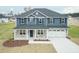Inviting two-story home with a two-car garage and covered front porch at 590 Glenkirk Pl, Garner, NC 27529