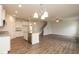 Open floor plan showcasing a kitchen with granite counters, stainless appliances, and adjacent living area at 590 Glenkirk Pl, Garner, NC 27529
