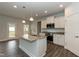 Spacious kitchen with a center island, granite countertops, and stainless steel appliances at 590 Glenkirk Pl, Garner, NC 27529