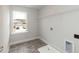 A practical laundry room with connections and natural light from the window at 590 Glenkirk Pl, Garner, NC 27529