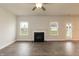 Bright living room with a fireplace, two windows and a glass panel door at 590 Glenkirk Pl, Garner, NC 27529