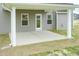 Outdoor patio with covered roof, two windows, and a back door at 590 Glenkirk Pl, Garner, NC 27529