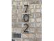 Close-up of the address '702' displayed on a textured brick wall of a residential property at 702 Portia Way, Homesite 16, Morrisville, NC 27560