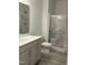 Bright bathroom featuring a modern vanity, a toilet, and a glass-enclosed shower at 702 Portia Way, Homesite 16, Morrisville, NC 27560