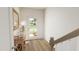 Bright entryway with wood floors, a rustic wood table, and a modern three-paneled door at 702 Portia Way, Homesite 16, Morrisville, NC 27560