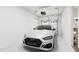 A clean garage featuring a white car and an automatic door opener at 702 Portia Way, Homesite 16, Morrisville, NC 27560