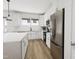 Well-lit kitchen featuring a large island, stainless steel appliances, and shaker style cabinets at 702 Portia Way, Homesite 16, Morrisville, NC 27560