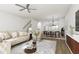 Open-concept living room and dining area with sleek furniture, a ceiling fan, and modern decor at 702 Portia Way, Homesite 16, Morrisville, NC 27560