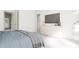 Bright main bedroom with a TV, dresser, and entry to a walk-in closet and ensuite bathroom at 702 Portia Way, Homesite 16, Morrisville, NC 27560