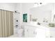 Bright bathroom featuring a shower with tan curtain, white vanity, and decorative artwork at 704 Portia Way, Homesite 15, Morrisville, NC 27560