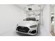 Spacious two car garage featuring a modern white vehicle parked inside and a garage door opener at 704 Portia Way, Homesite 15, Morrisville, NC 27560