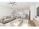 Open-concept living room with a comfortable sofa, ceiling fan, and view to the kitchen and dining area at 704 Portia Way, Homesite 15, Morrisville, NC 27560