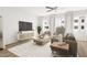 Inviting living room with large windows, comfortable seating, and a stylish entertainment center at 704 Portia Way, Homesite 15, Morrisville, NC 27560