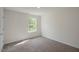 A well-lit carpeted bedroom with a single window allowing natural light to enter the living space at 1128 Middlecrest Dr, Rocky Mount, NC 27804