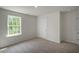 Bright bedroom featuring a large window and neutral carpet, creating a cozy and inviting atmosphere at 1128 Middlecrest Dr, Rocky Mount, NC 27804