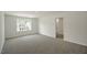 A spacious bedroom features neutral carpet, natural light, and an entrance to the bathroom at 1128 Middlecrest Dr, Rocky Mount, NC 27804