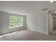 Spacious carpeted bedroom with lots of natural light coming from the large window, complete with overhead lighting at 1128 Middlecrest Dr, Rocky Mount, NC 27804