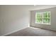 Light filled bedroom with a neutral carpet, and a single window bringing in natural light at 1128 Middlecrest Dr, Rocky Mount, NC 27804