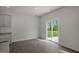 A kitchen and dining area with light gray wood-look floors and a sliding glass door at 1128 Middlecrest Dr, Rocky Mount, NC 27804