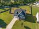 Aerial view of a two-story house with a large backyard and a long driveway at 20 Julep Ct Rd, Youngsville, NC 27596