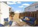 Relaxing backyard patio with cozy outdoor seating, privacy fence, and a well-maintained lawn at 2248 Ventana Ln, Raleigh, NC 27604