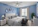 Serene blue bedroom with a large window, modern furniture, and soft, neutral decor at 2248 Ventana Ln, Raleigh, NC 27604
