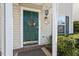 Inviting front door with green paint, a seasonal wreath and sidelight window showing exterior features at 2248 Ventana Ln, Raleigh, NC 27604