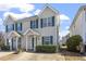 Inviting townhome exterior with lush landscaping, green shutters and a well-maintained lawn at 2248 Ventana Ln, Raleigh, NC 27604