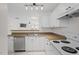 Cozy kitchen featuring white cabinetry, stainless steel appliances, and an open view to the living room at 2248 Ventana Ln, Raleigh, NC 27604
