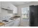 Well-maintained kitchen includes white appliances, ample cabinet space, and natural light from the window at 2248 Ventana Ln, Raleigh, NC 27604