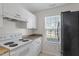 Functional kitchen area with white cabinets, stainless steel appliances, and neutral countertops at 2248 Ventana Ln, Raleigh, NC 27604
