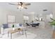 Bright living room features modern decor, ceiling fan, and adjacent dining area with seating for four at 2248 Ventana Ln, Raleigh, NC 27604