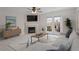 Living room with fireplace, TV, and patio access through glass paneled doors; neutral colors and lots of light at 2248 Ventana Ln, Raleigh, NC 27604
