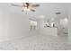 Spacious living area with marble floors, ceiling fan, window and view into the kitchen at 2248 Ventana Ln, Raleigh, NC 27604
